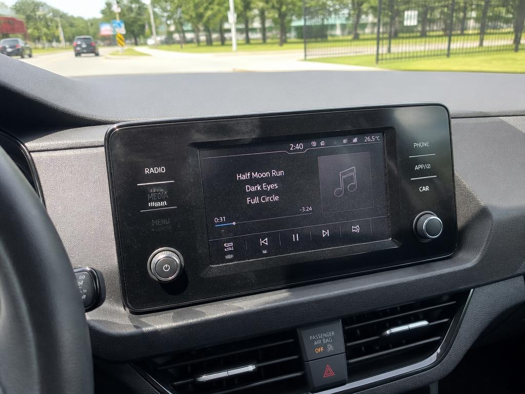 A car dashboard screen showing the song currently playing